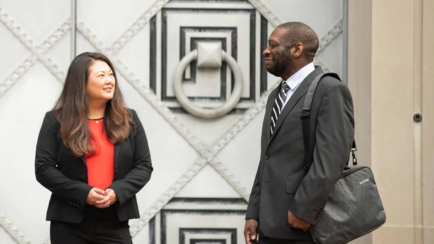 Male FBI employee speaking to female employee outside