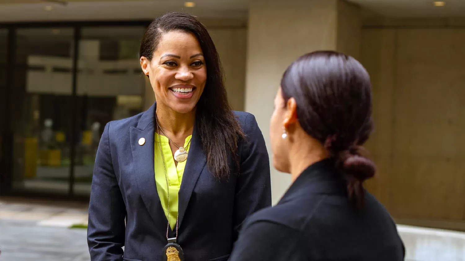 Female FBI Agent smiling and speaking to female